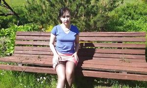 Sunny, but windy day in may 2020. A bench in a garden