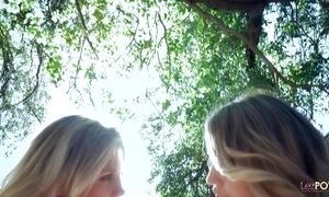 Lesbo blondes strip each other off in the woods before