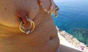 nippleringlover horny milf extreme pierced nipples and pussy nude outdoors on the beach part one