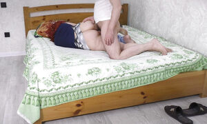 The stepmom deliberately lay down on the bed so that her stepson would have sex with her