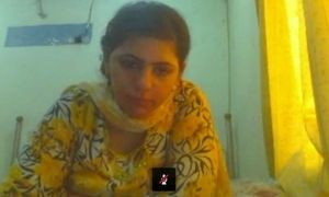 Lahori housewife Saba demonstrating yam-sized milk cans on web cam